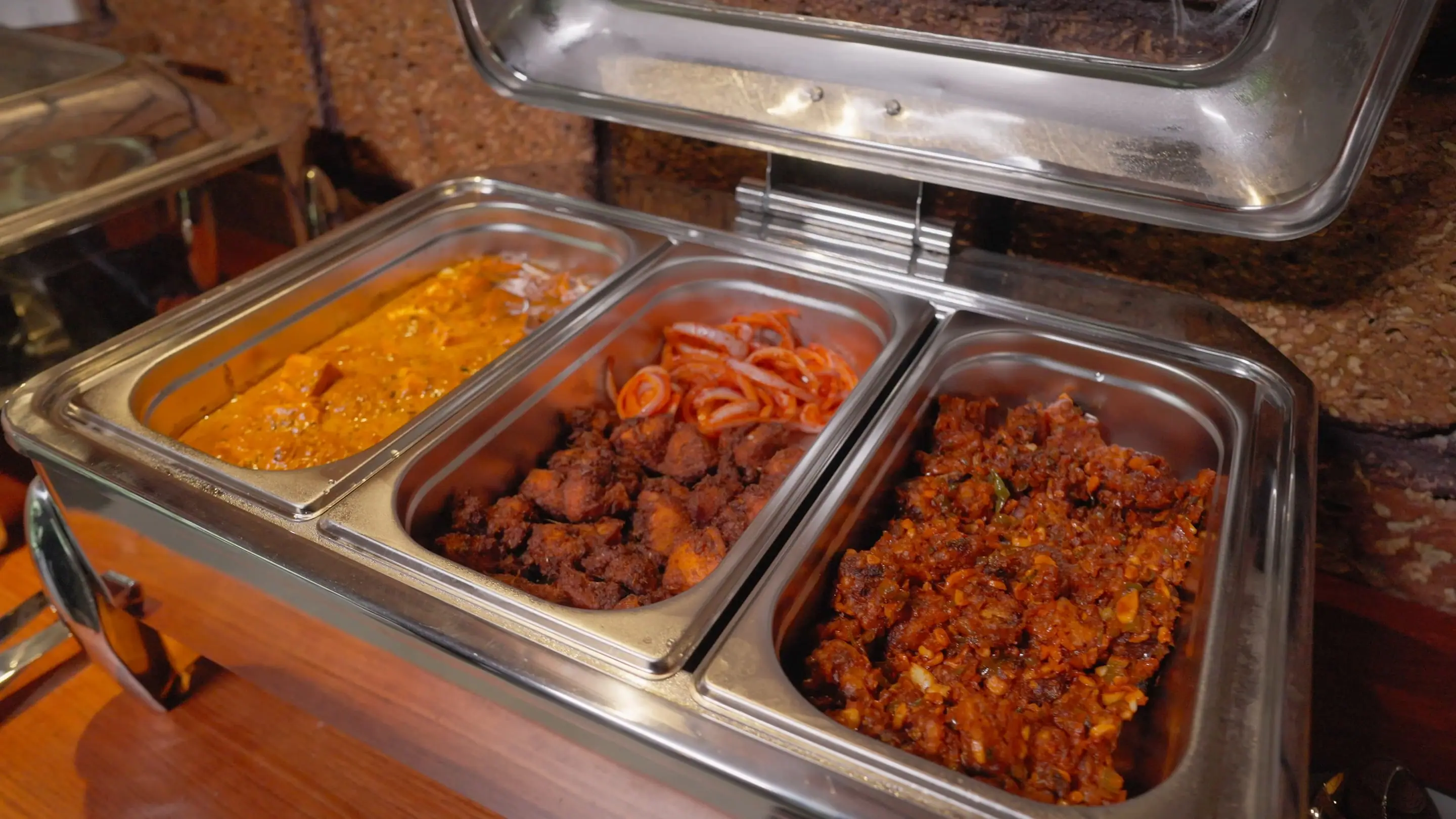 Chafing dishes of curries on the buffet counter