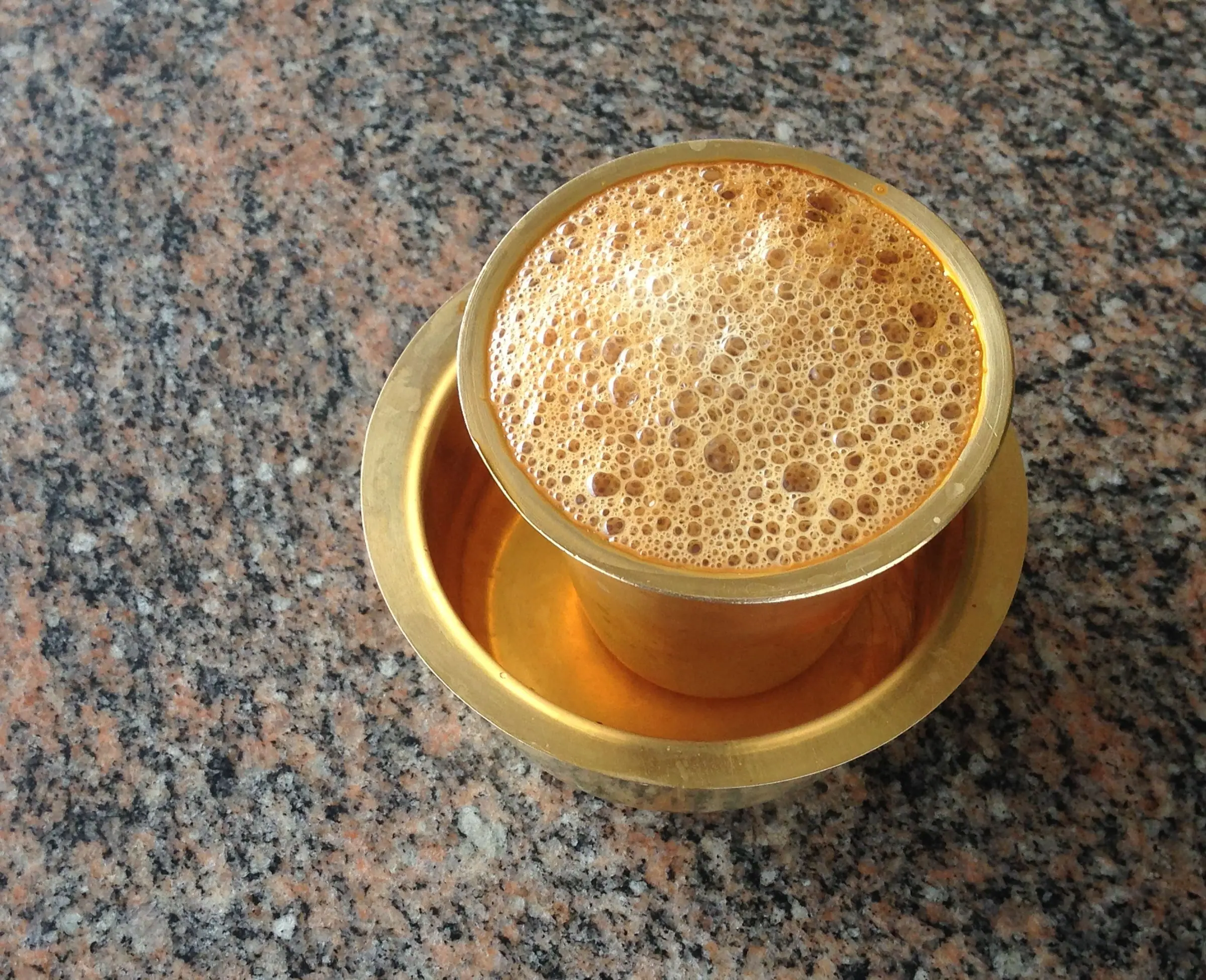 South Indian filter coffee in a brass tumbler and davara