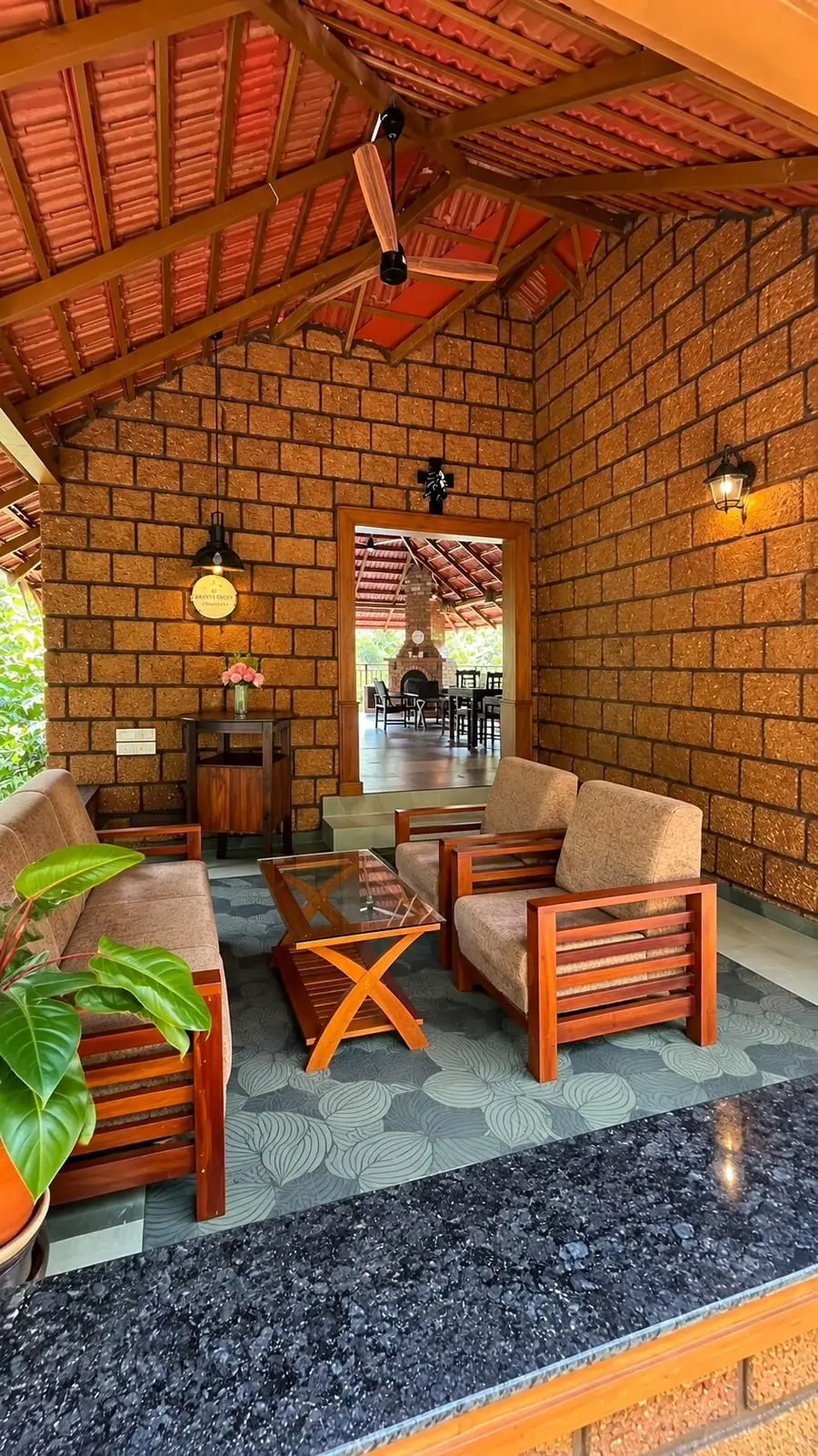 The laterite lounge, the round Mokha Grove plaque on the wall and the dining pavilion through the doorway
