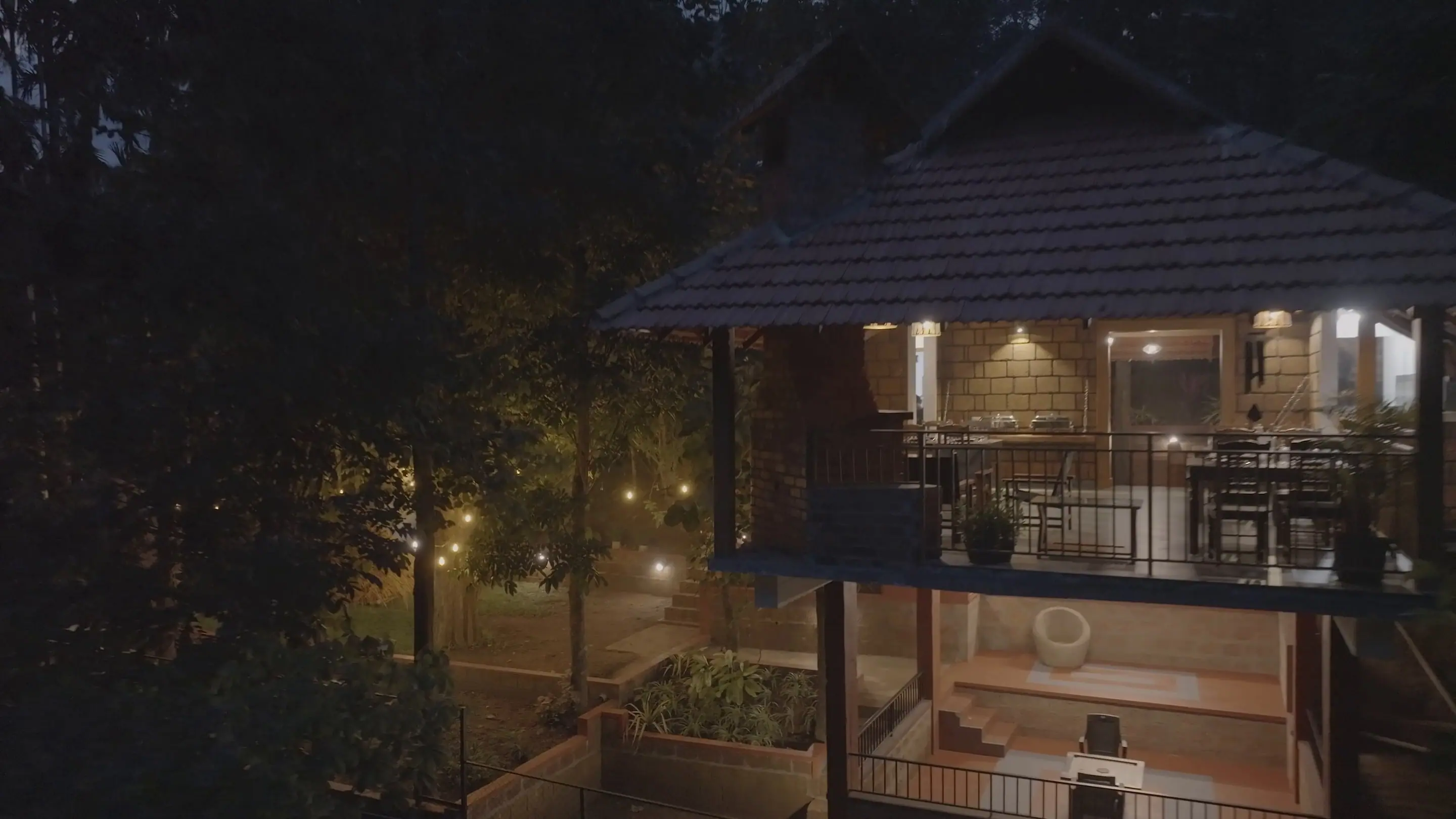 The dining pavilion glowing among dark trees at night