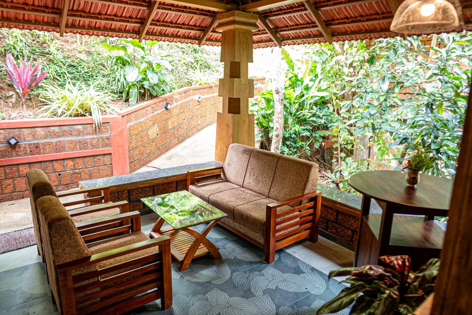 Timber sofas and chairs in the laterite lounge, opening onto the planted terraces outside