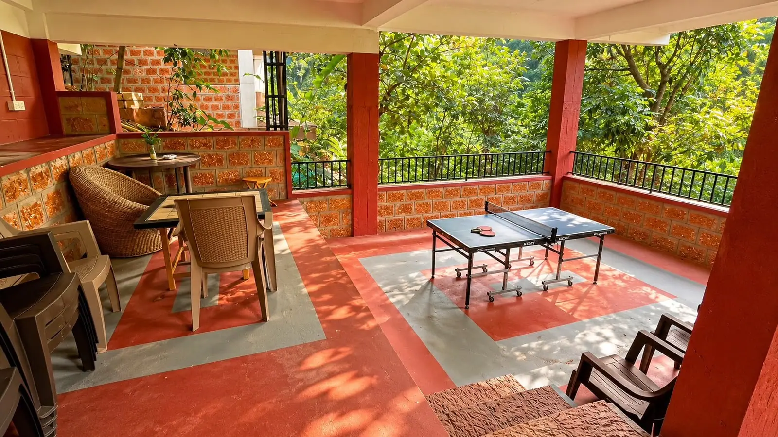 A table-tennis table on the red-floored veranda